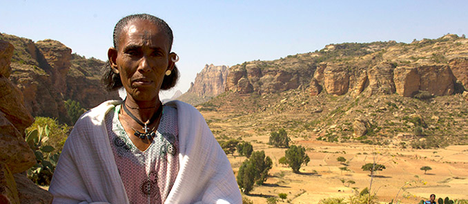Shefina Kahsay, surrounded by the rocky terrain of her home in Northern Tigray, Ethiopia
