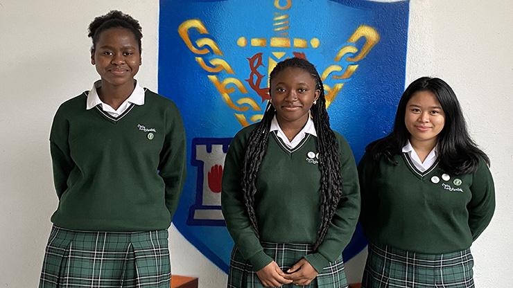 Three young girls wearing their school uniform who have just won the Science for Development Award 2022. 